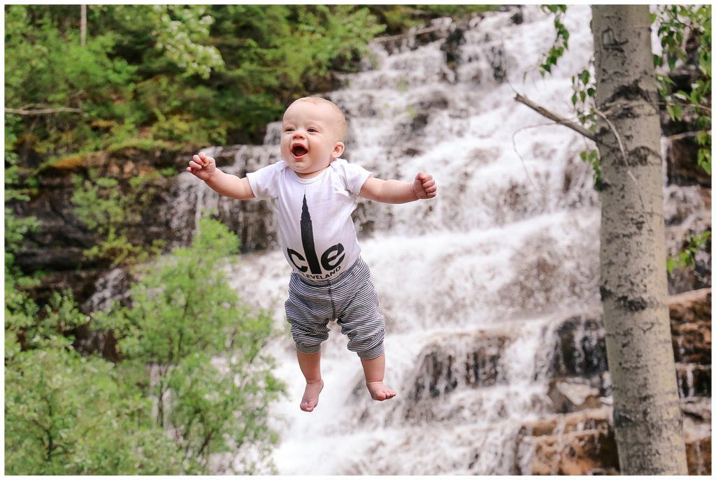 Little boy flying in front of a waterfall, first flying baby shot of Erin Thompson.