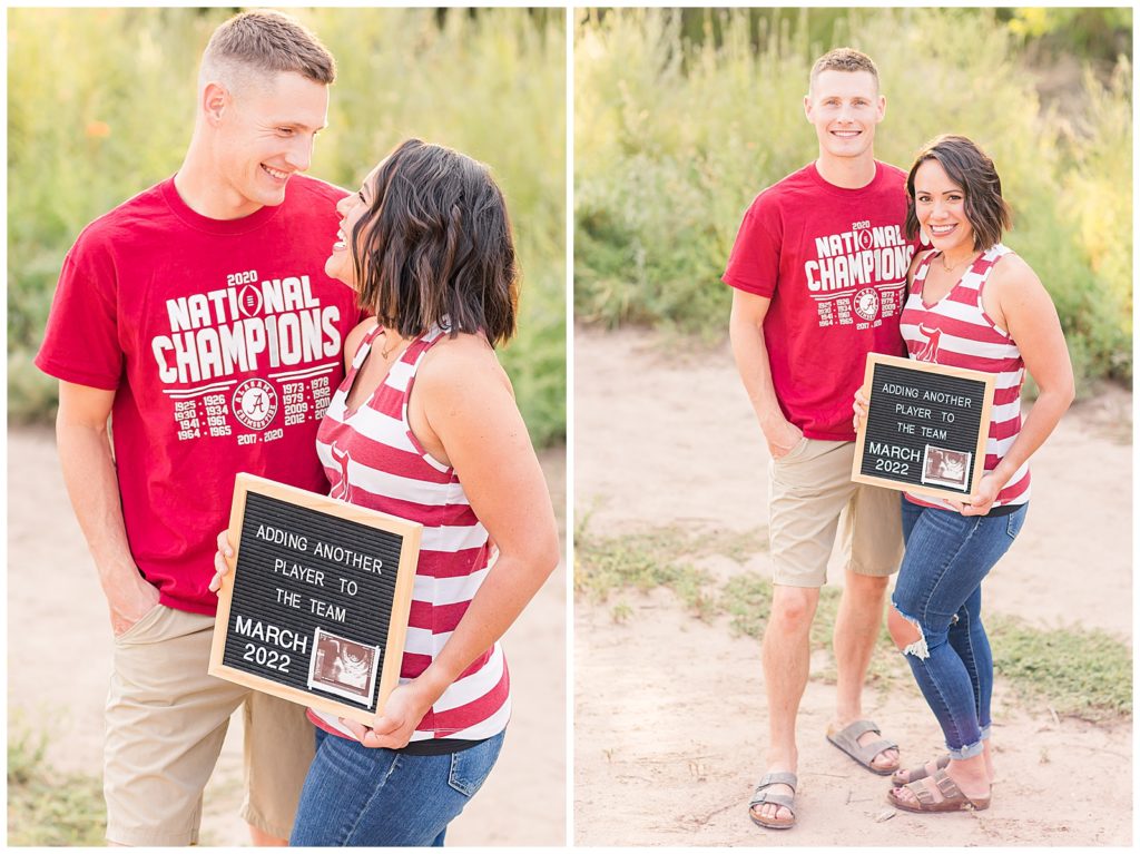 Husband and wife holding a letter board with a pregnancy announcement