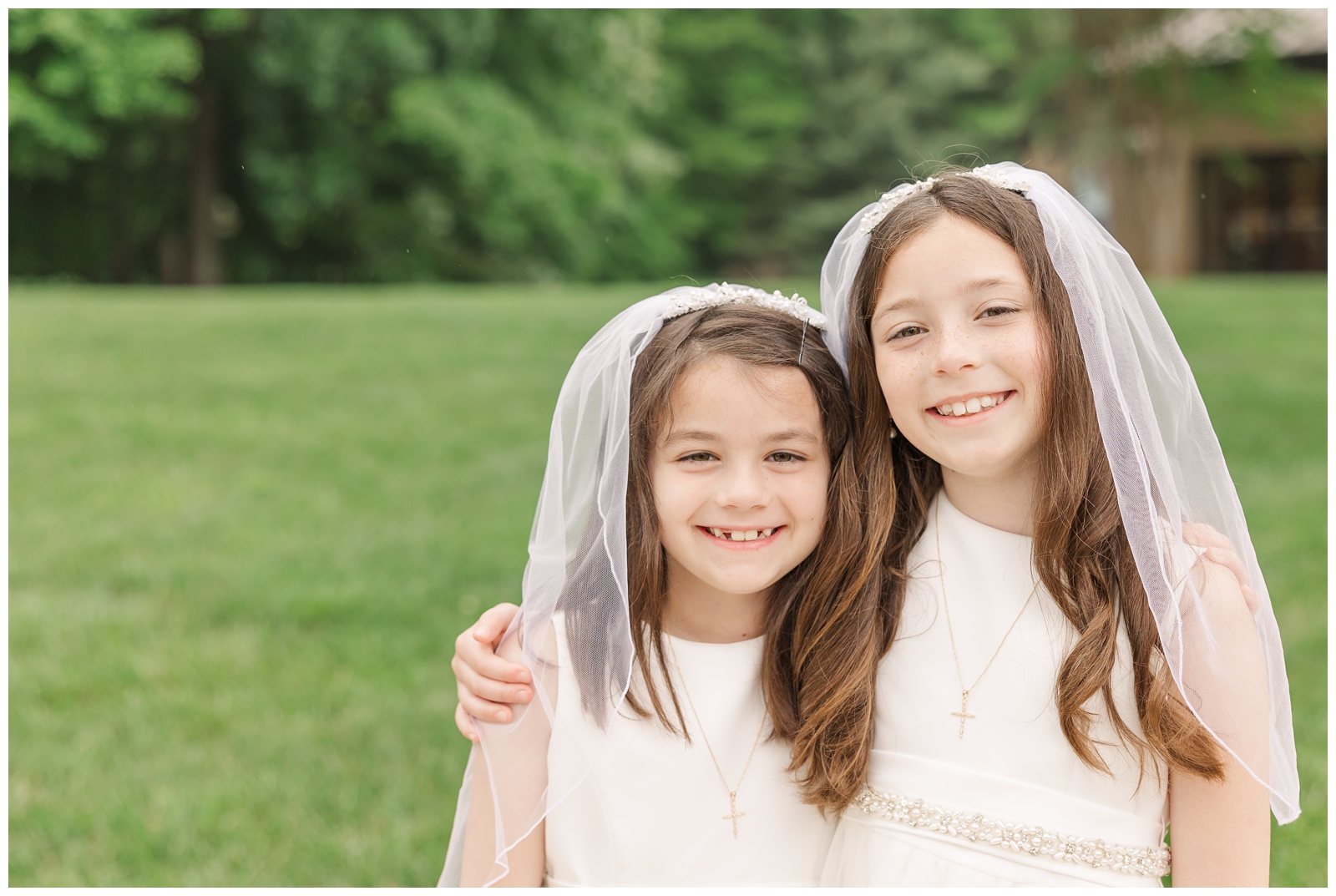 Twin sisters smiling at their First Communion