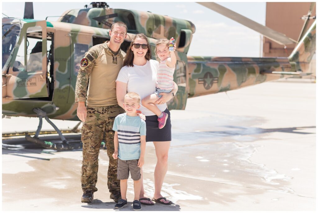 Erin Thompson Photography and family standing in front of an Air Force helicopter