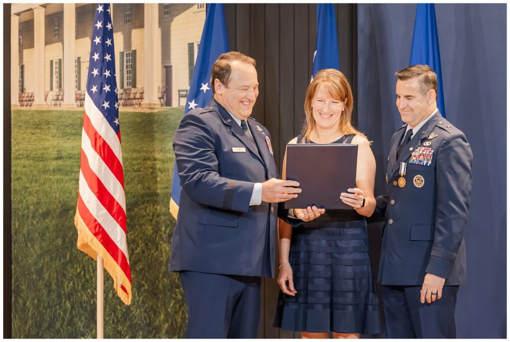 Spouse receives a certificate at Air Force retirement ceremony