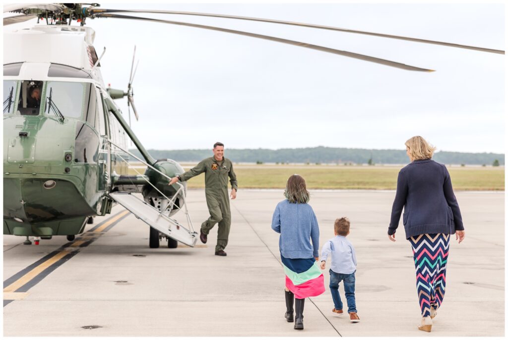 Pilot greeting his family outside Marine helicopter