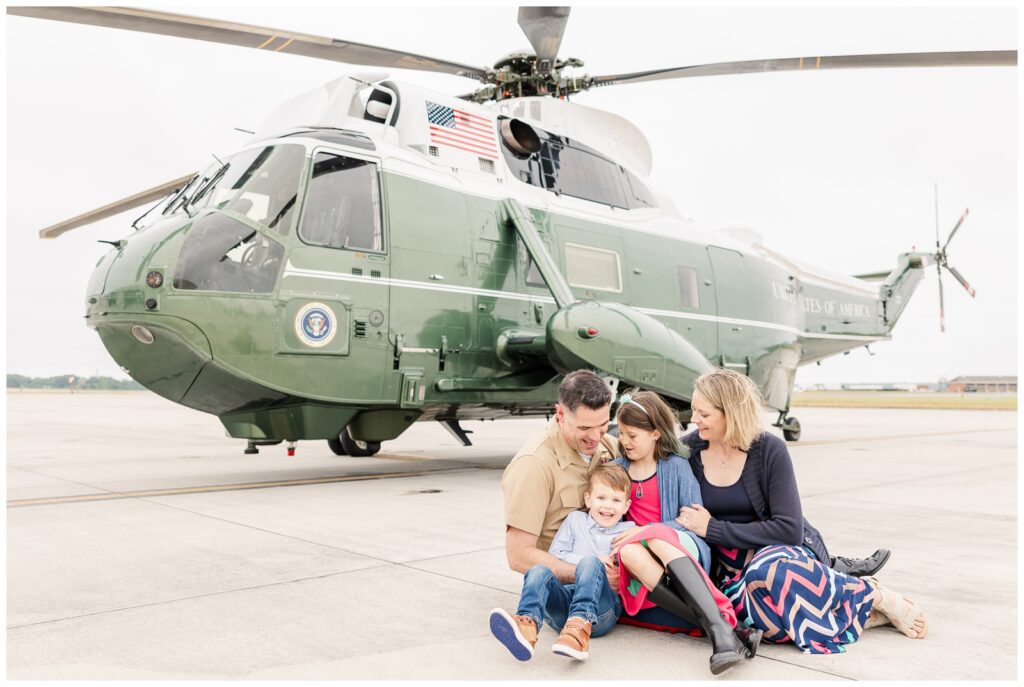Family laughing in front of Marine One aircraft