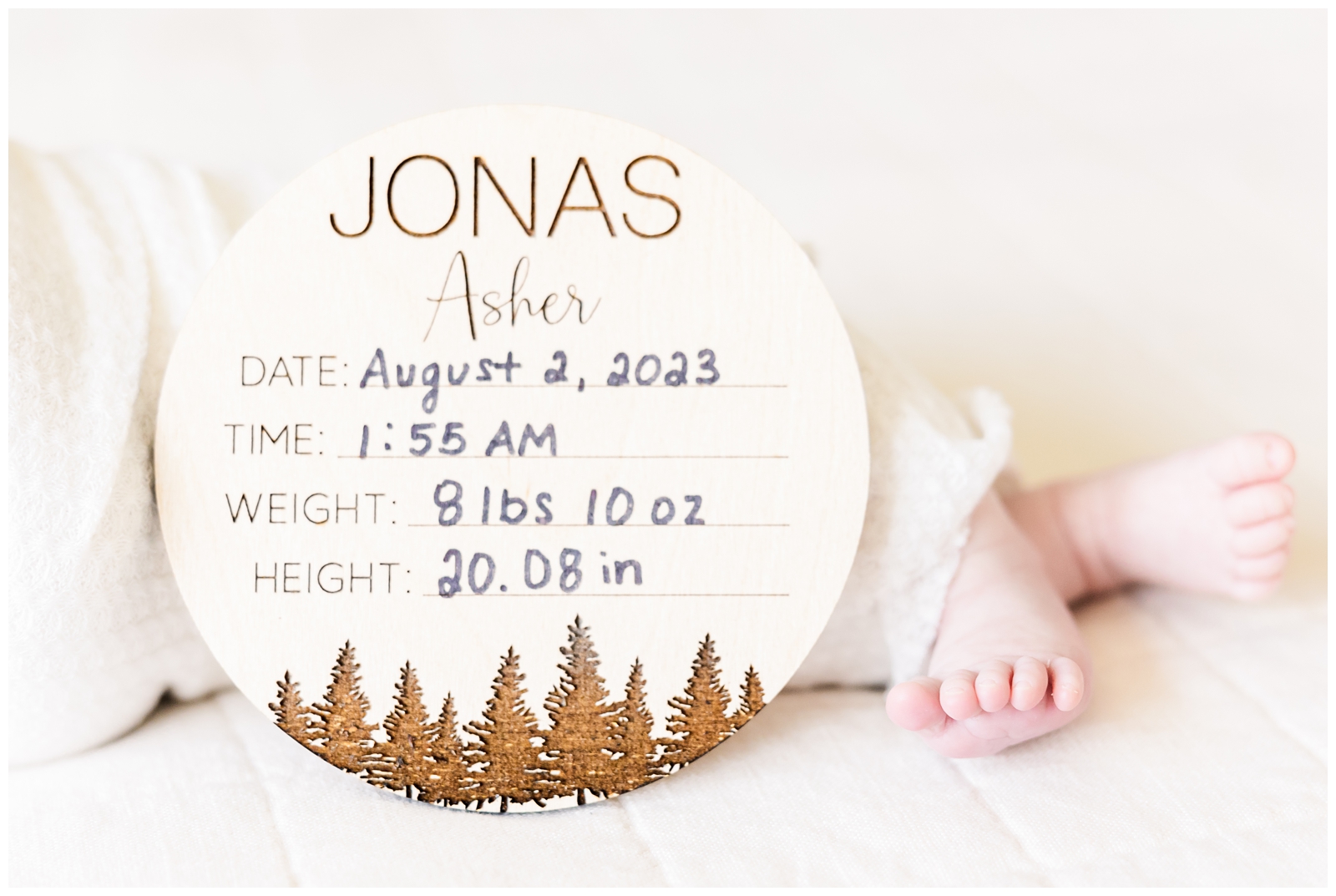 Baby feet with birth stats sign