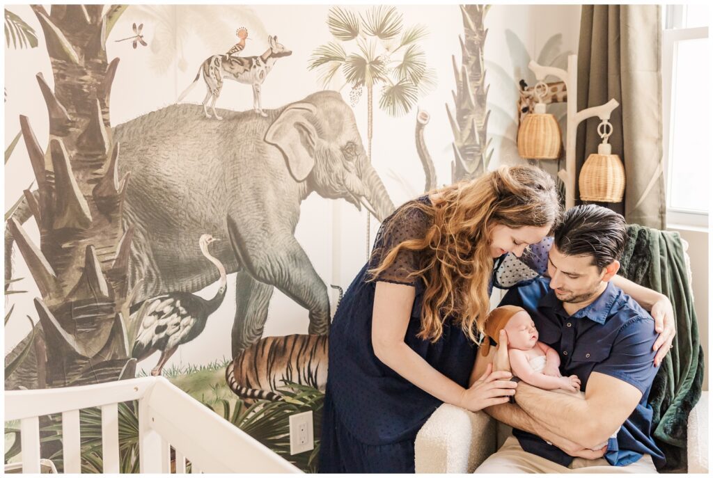 Family snuggling in the jungle nursery at their DC newborn photography session
