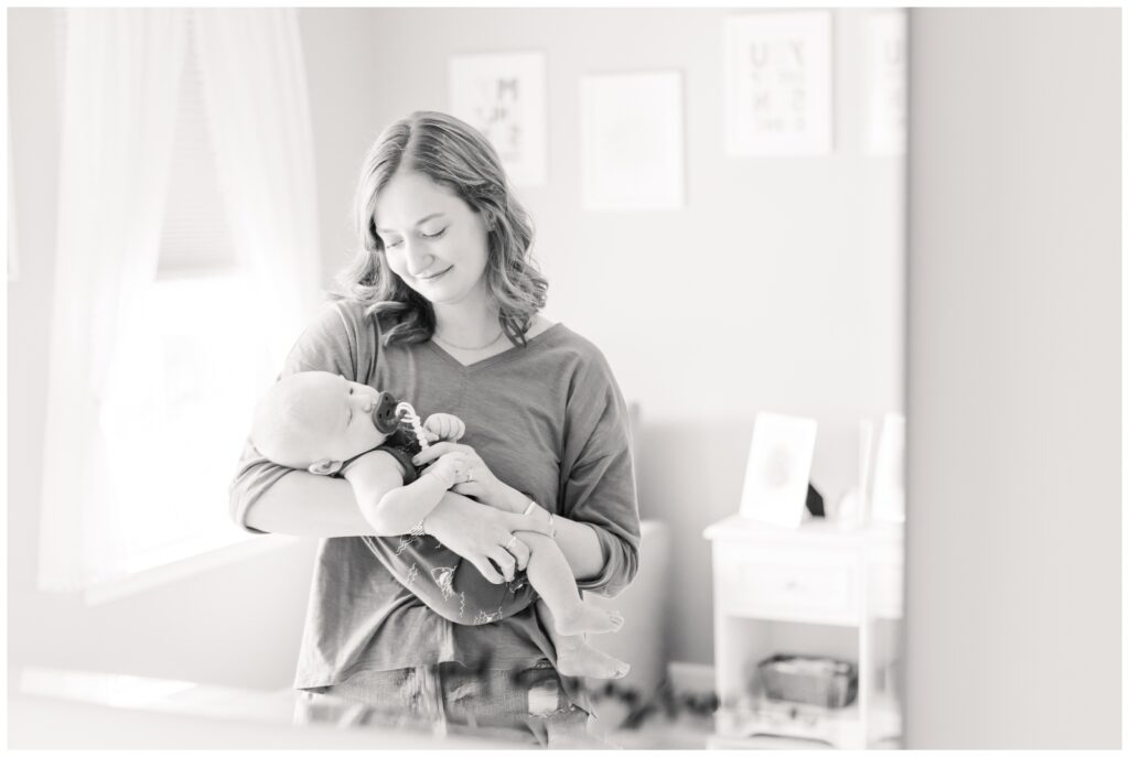 Mom rocking baby during lifestyle newborn photography session