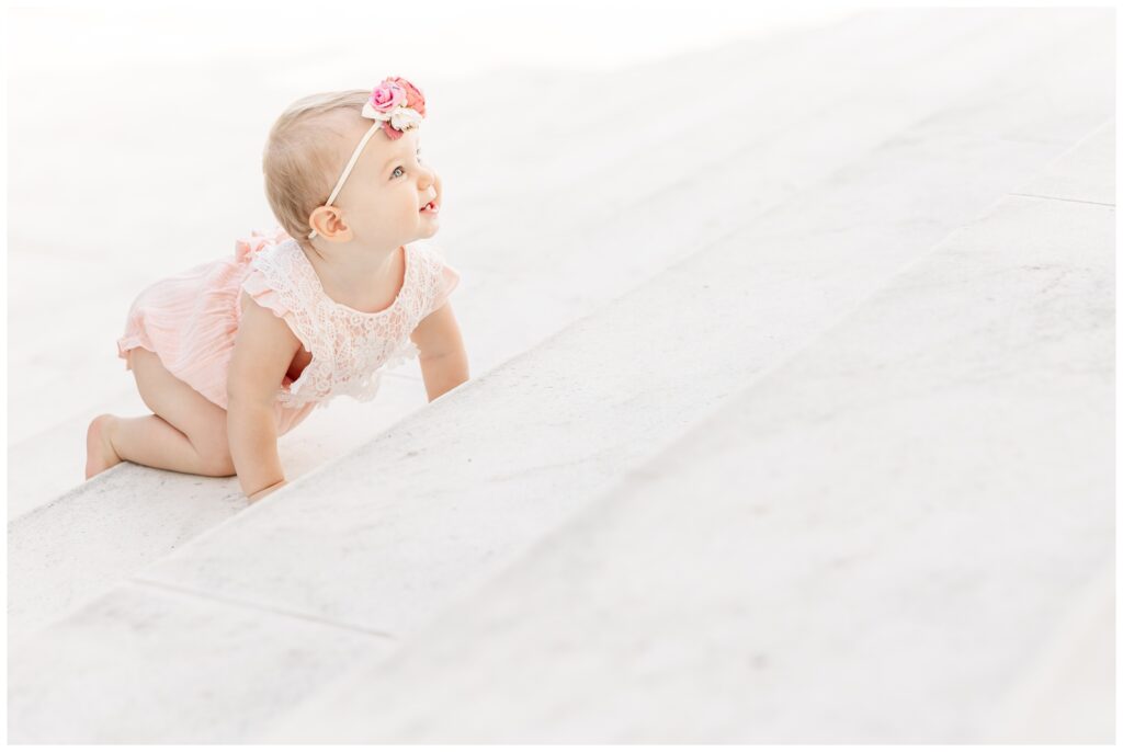 Baby girl crawling on the Jefferson Memorial steps in Washington DC