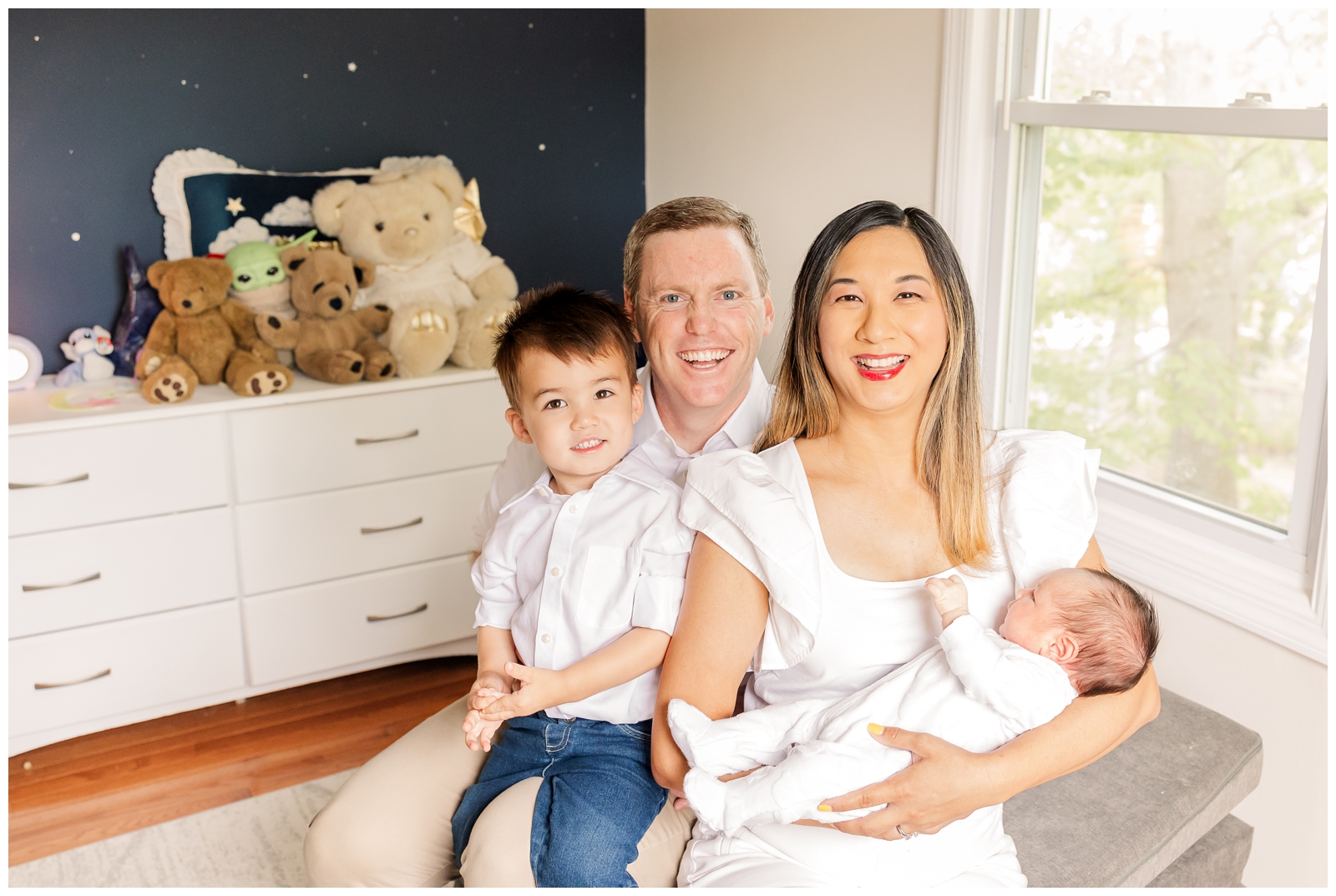 Family smiling during an Alexandria newborn photography session