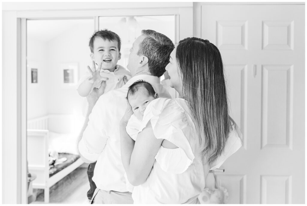Family laughing during their Alexandria newborn photography session