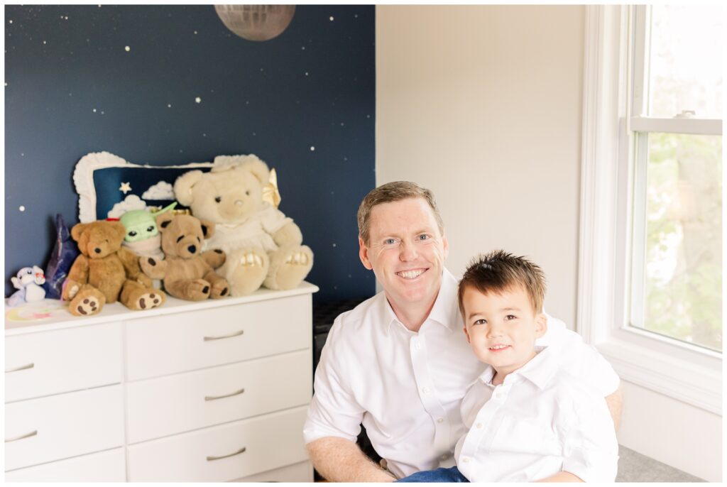 Father and son smiling at their family's Alexandria newborn photography session