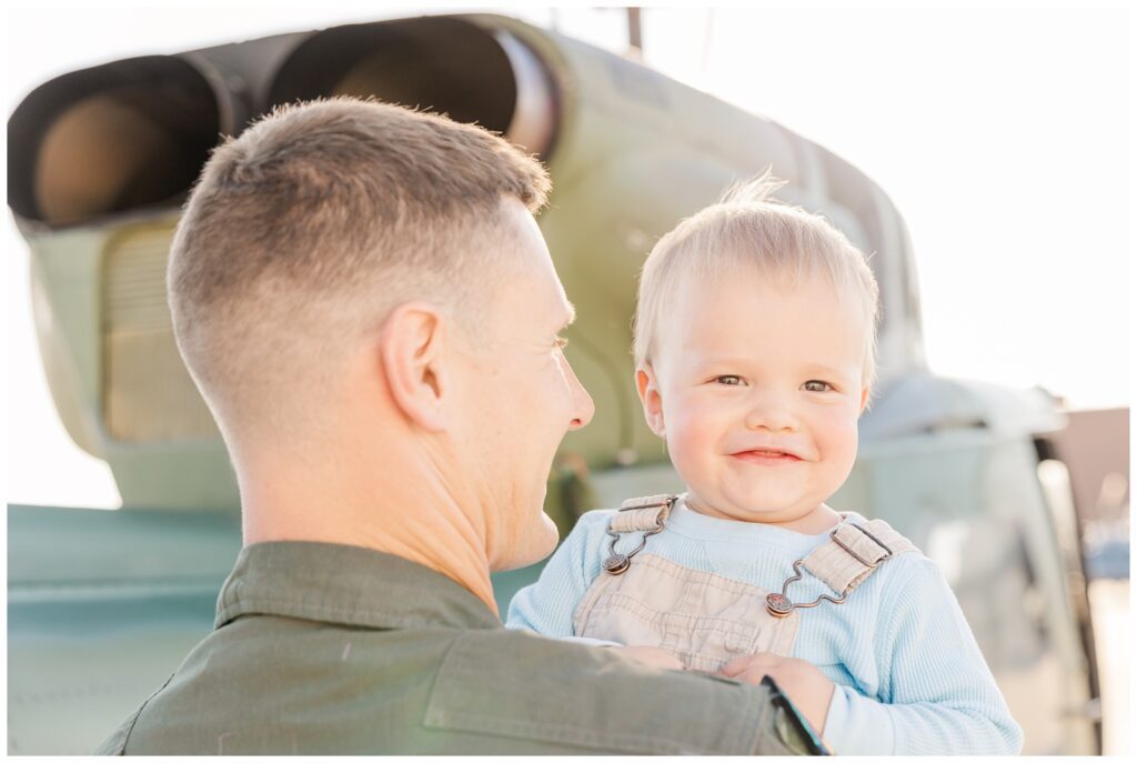 Toddler smiling with dad during flight line family photos