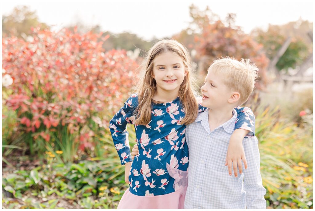 Brother and sister smiling during a fall mini session