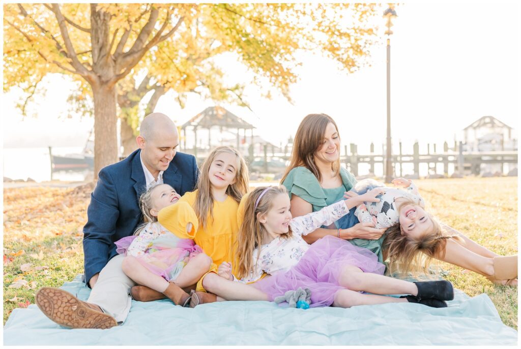 Family playing during family photos at Founders Park