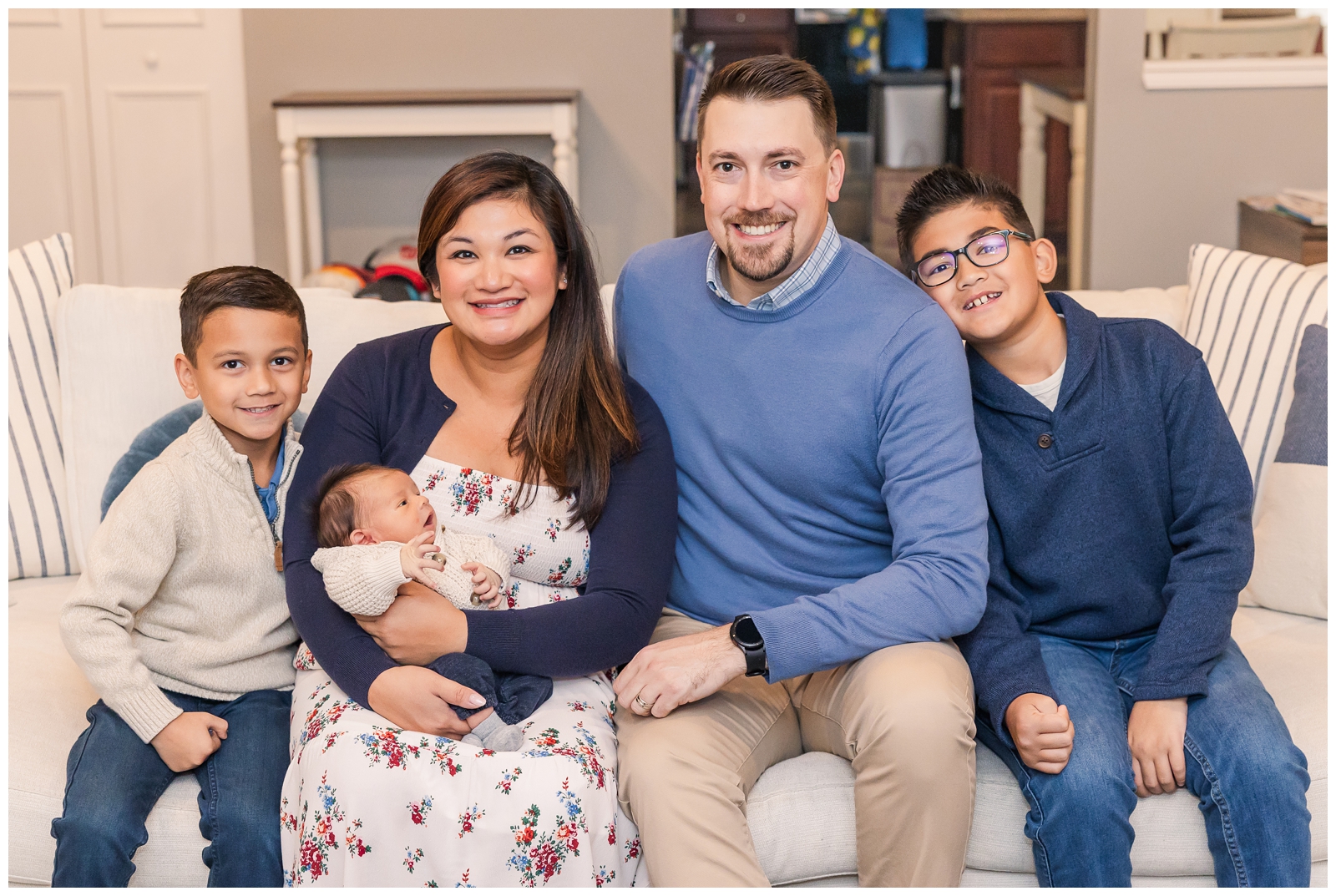 Parents and three sons smiling during Virginia newborn session