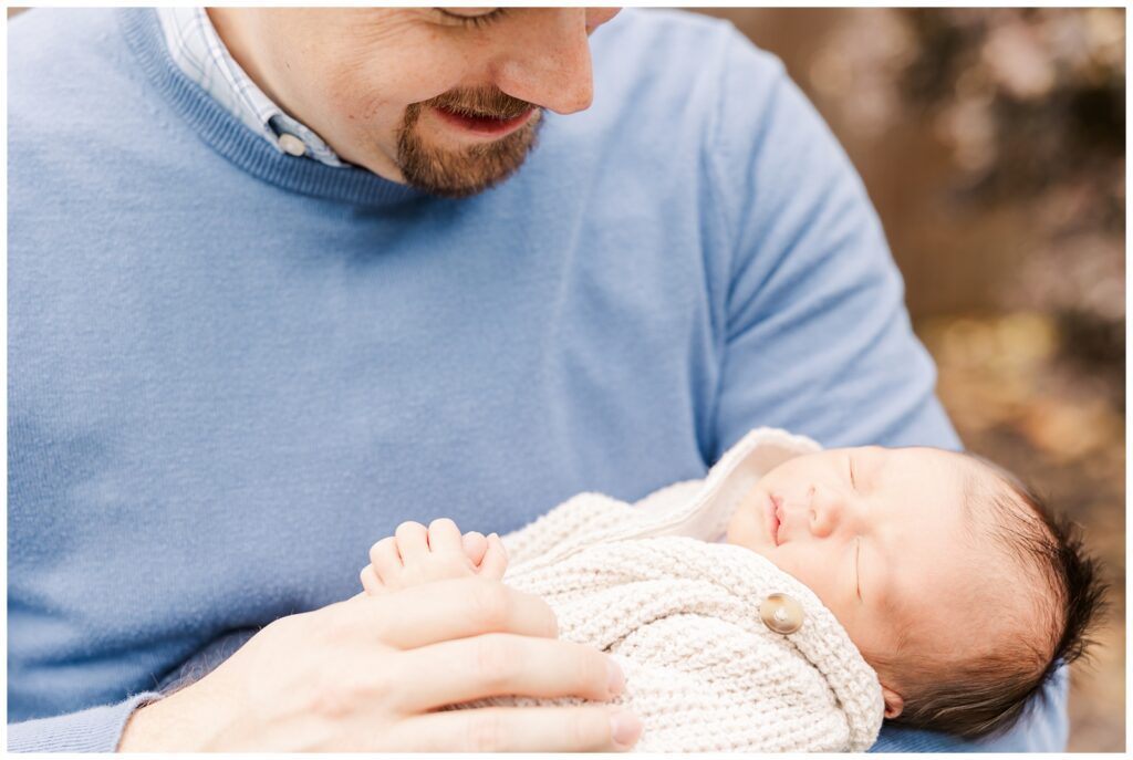 Dad holding his youngest son during their Virginia newborn session