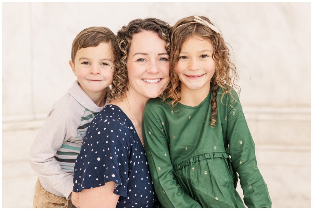 Mom smiling with her two youngest kiddos during their Jefferson Memorial family session
