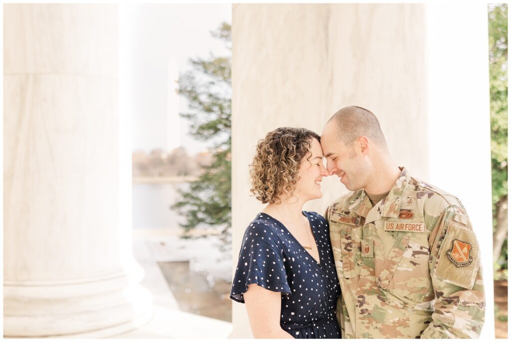 Air Force couple standing forehead to forehead in the Jefferson Memorial