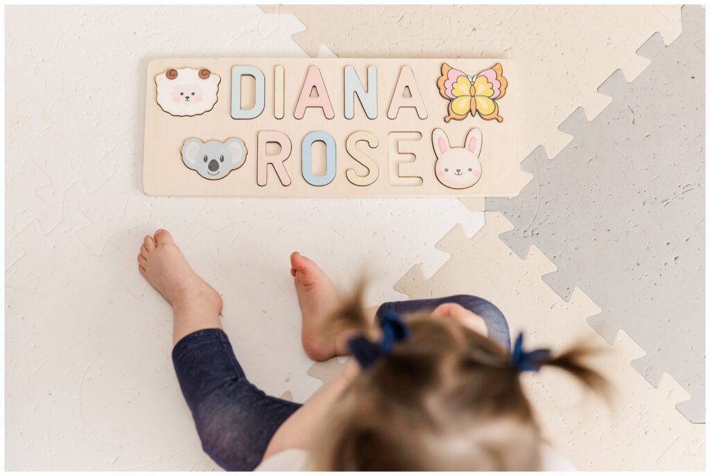 Toddler playing with a puzzle during Alexandria lifestyle photography session