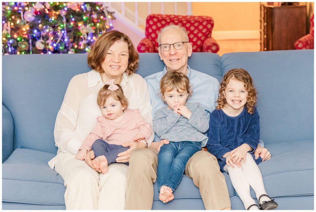 Grandparents holding their granddaughters during extended family photos