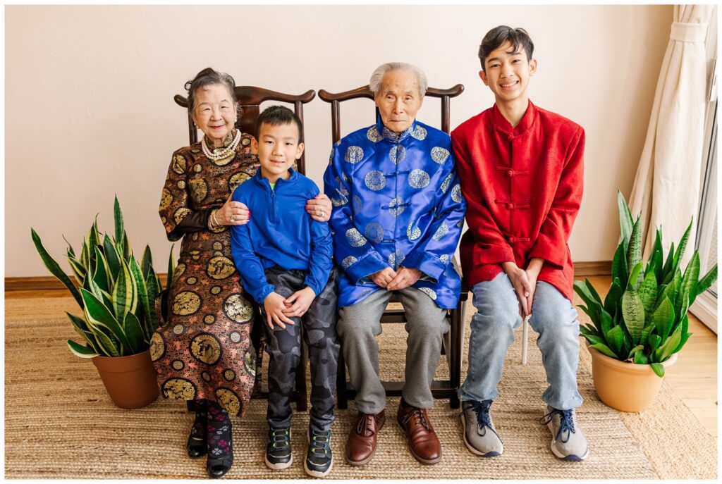 Grandparents sitting with two of their grandsons during their extended family photography session
