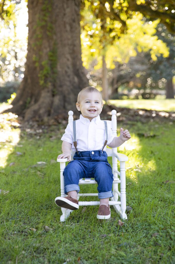 Little boy sitting in a rocking chair at Memorial Park in K. Z. Wentzel's Sumter, SC photography spotlight