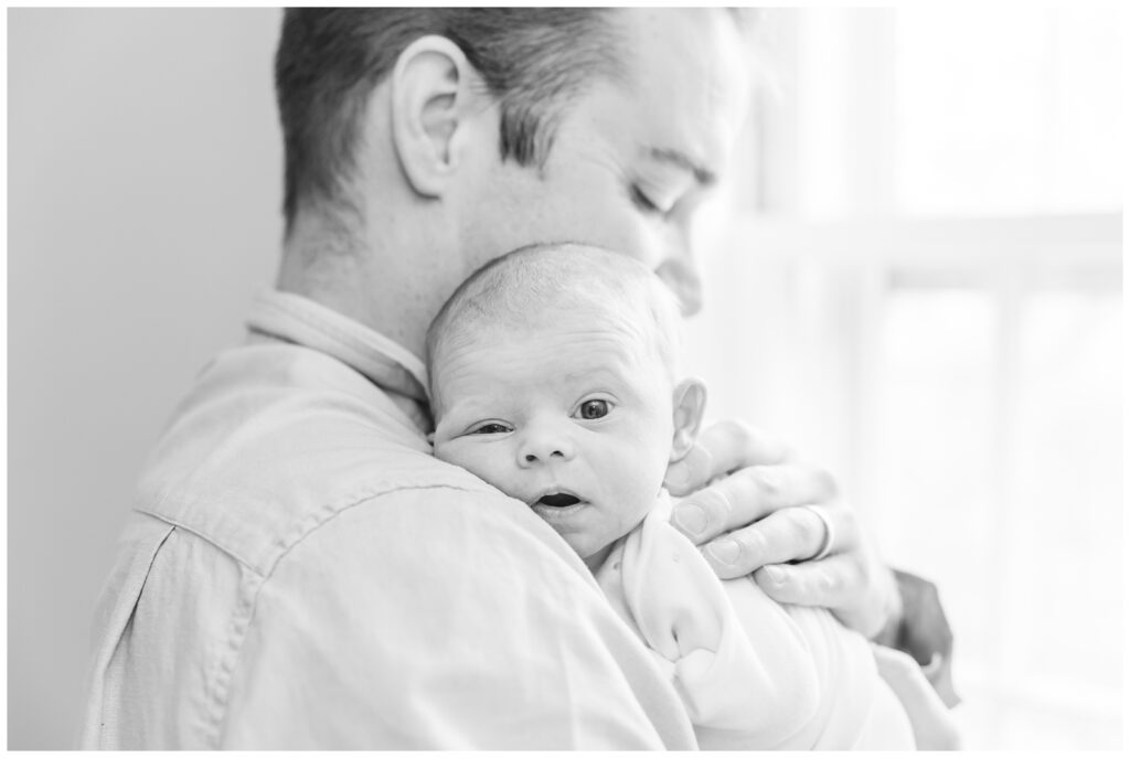 Baby resting on dad's shoulder during Arlington newborn photos