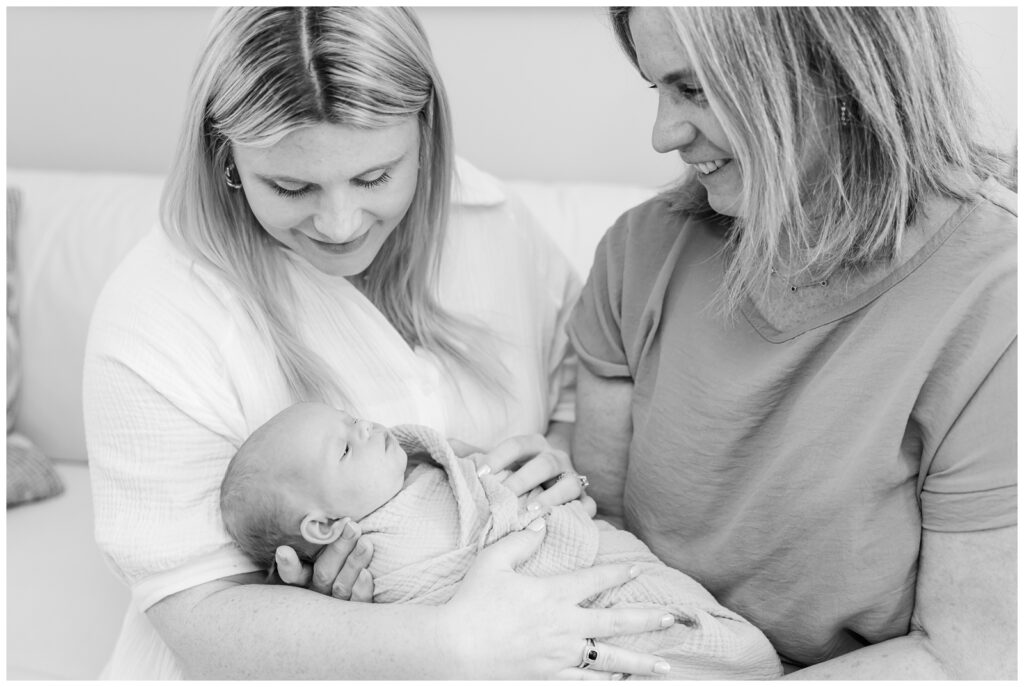 New mom and grandma holding baby girl during Arlington newborn photos