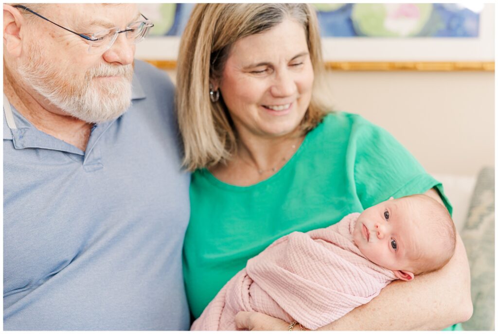 Grandparents holding their first granddaughter