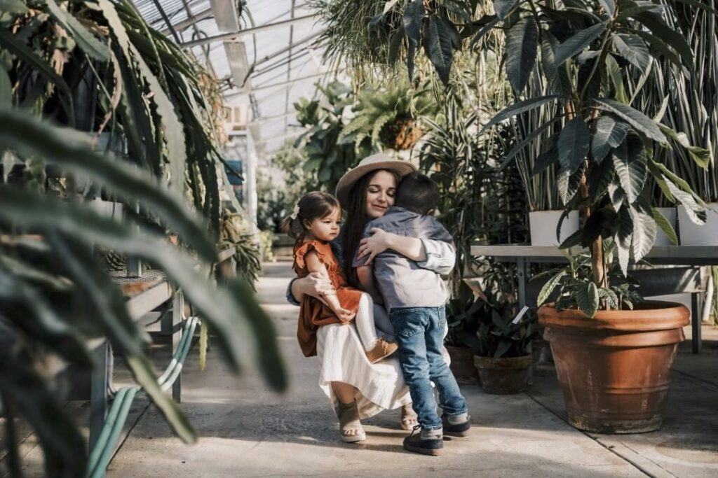 Mom hugging her two kids at Mann Leiser Memorial Greenhouse in Melanie Lopez Photography's Anchorage, AK photography spotlight
