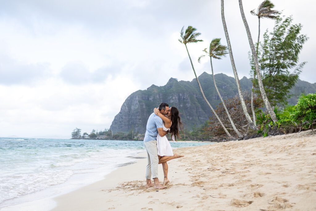 Couple kissing on Kaaawa Beach in Kelly Stewart Photography's Mililani, HI photography spotlight