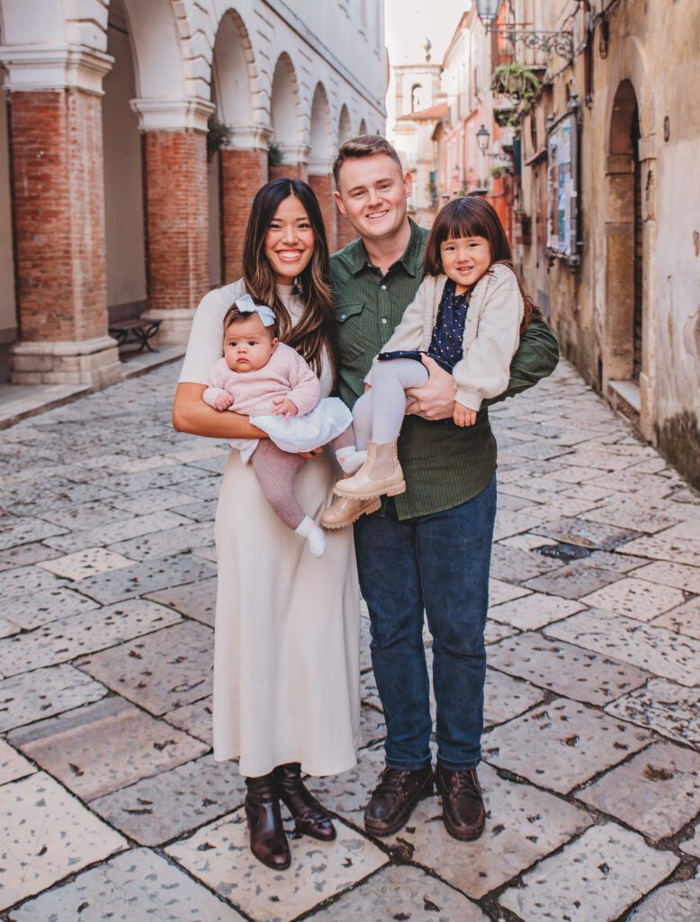 Parents holding their two young daughters at Sant'Agata de' Goti in The Backpack Photographer's Naples, Italy photography spotlight