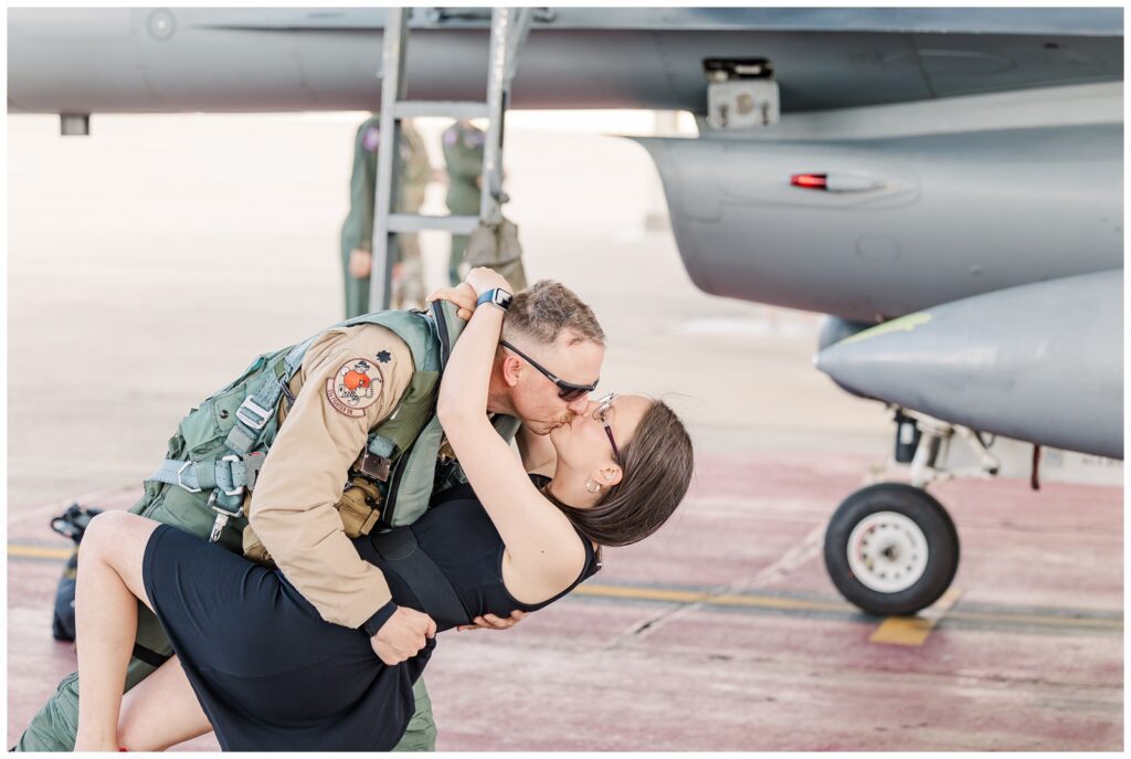 Piloting kissing his wife at his Air Force deployment homecoming