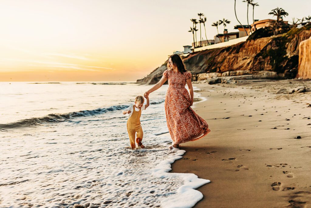 Mother and child walking along Terramar Beach in Christa Paustenbaugh Photography's Oceanside, CA Photography Spotlight