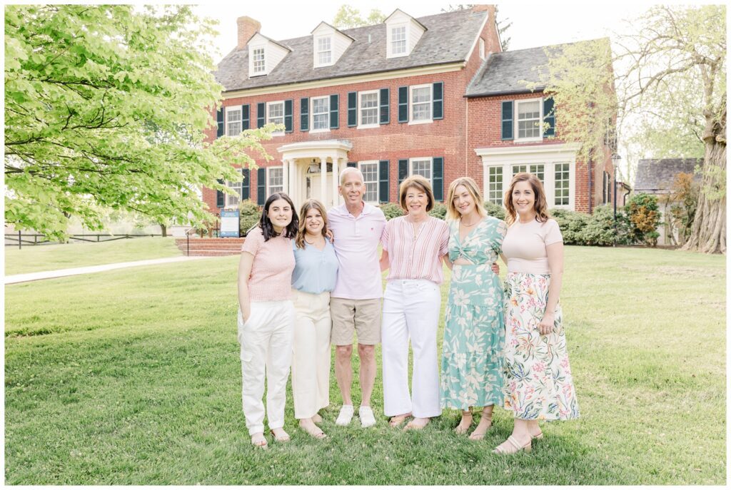 Parents smiling with their adult daughters during Maryland extended family photos