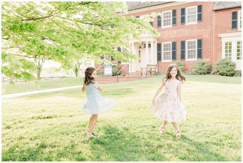 Cousins twirling in the grass at Woodlawn Manor Cultural Park