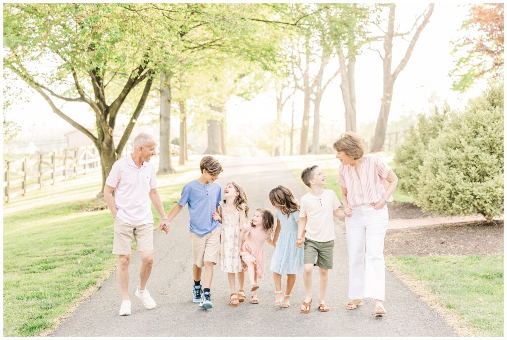 Grandparents holding hands and walking with their grandchildren during Maryland extended family photos