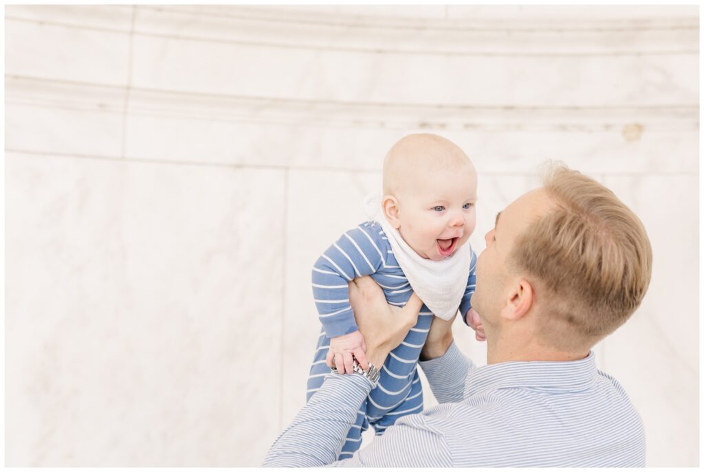 Dad tossing baby in the air during their Washington DC photography session
