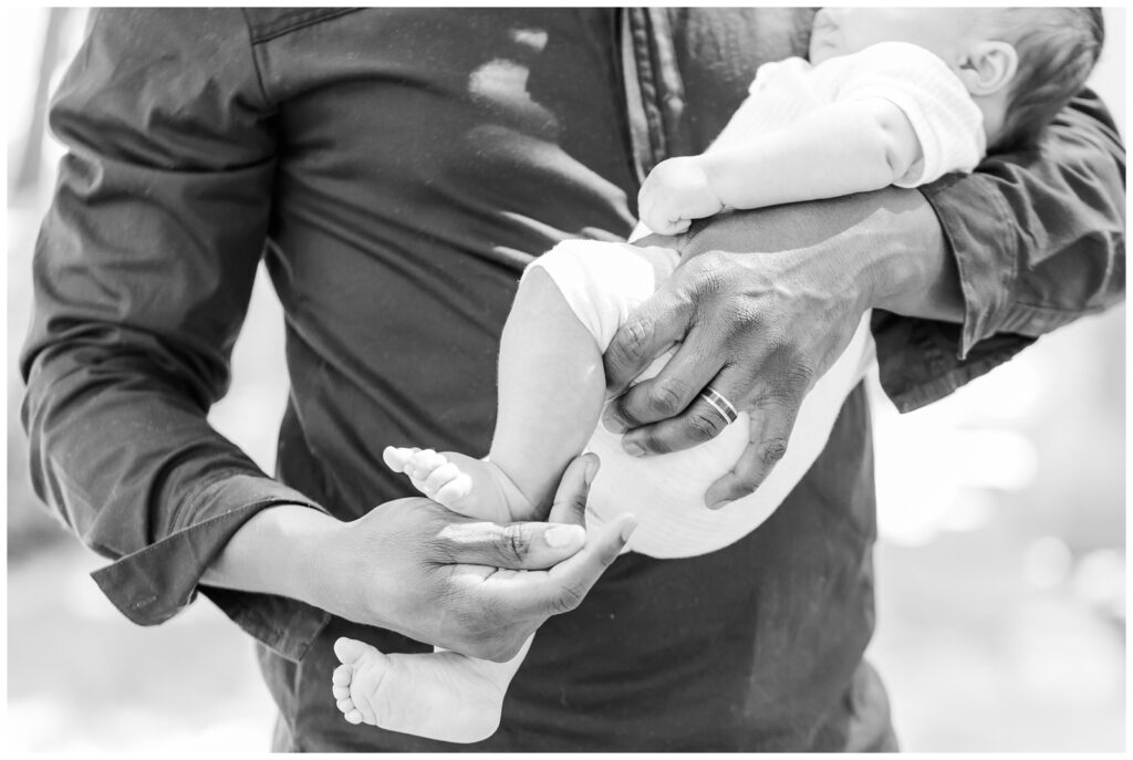 Close up of dad's hands holding baby during Washington DC newborn session