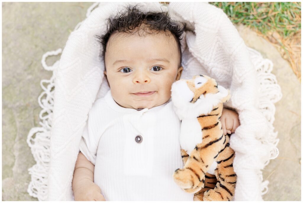 Baby boy holding his stuffed animal tiger