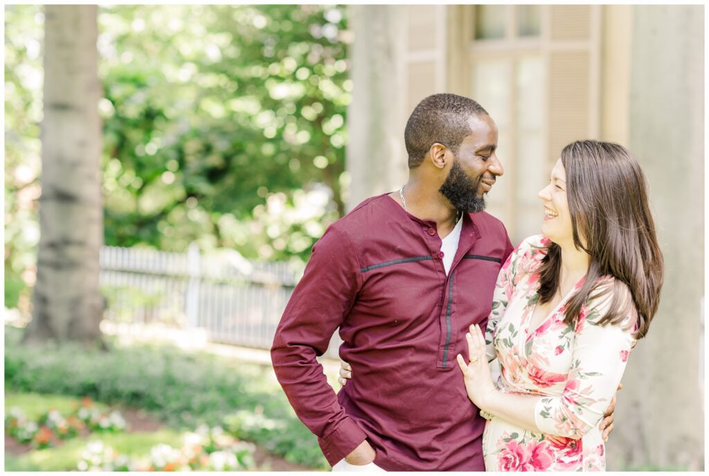 New parents laughing towards each other during Washington DC newborn session