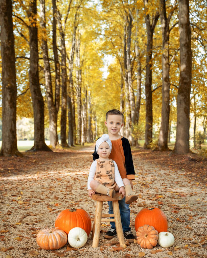 Young siblings sitting with pumpkins in Di Villa Varda Park in Soukchay Sylakhom Photography's Aviano, Italy Photography Spotlight