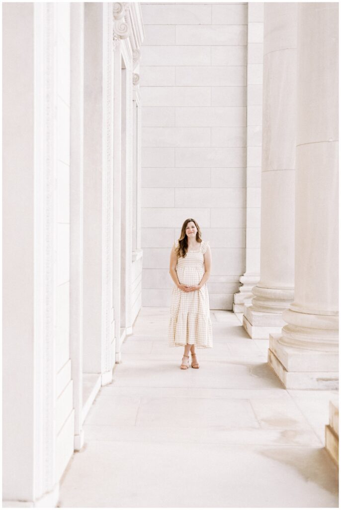 Pregnant mama holding her belly at the state capitol in Victoria Mendoza Photography's Little Rock, AR Photography Spotlight