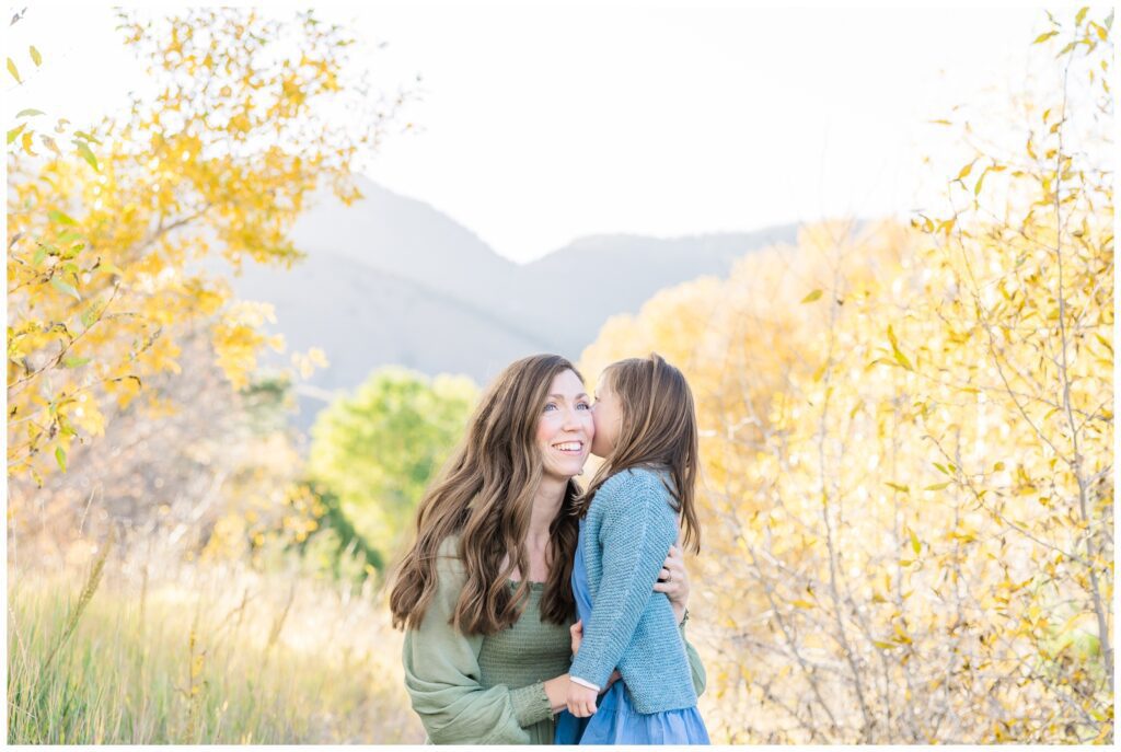 Little girl whispering in her mom's ear in Monument, CO