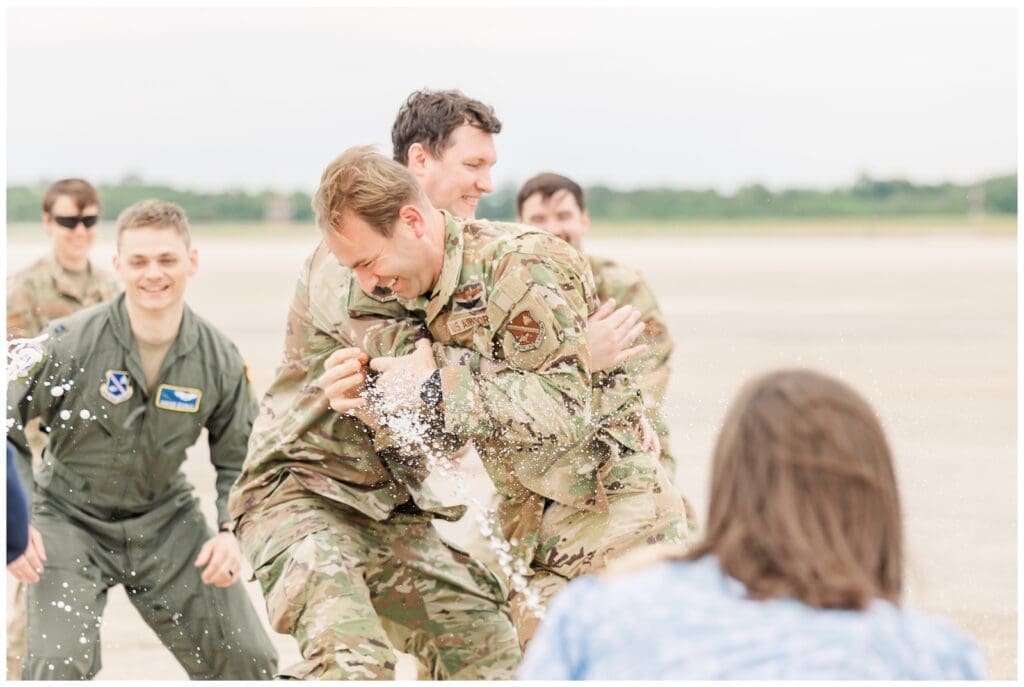 Aircrew wrestling with pilot during fini flight celebration
