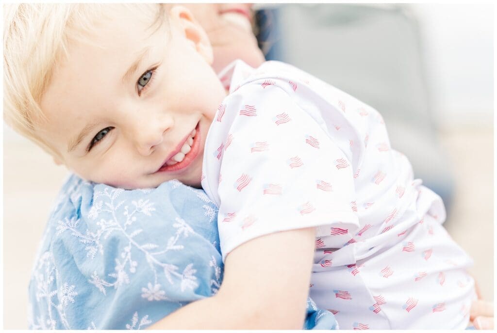 Little boy smiling on his mom's shoulder by a Colorado Springs fini flight photographer