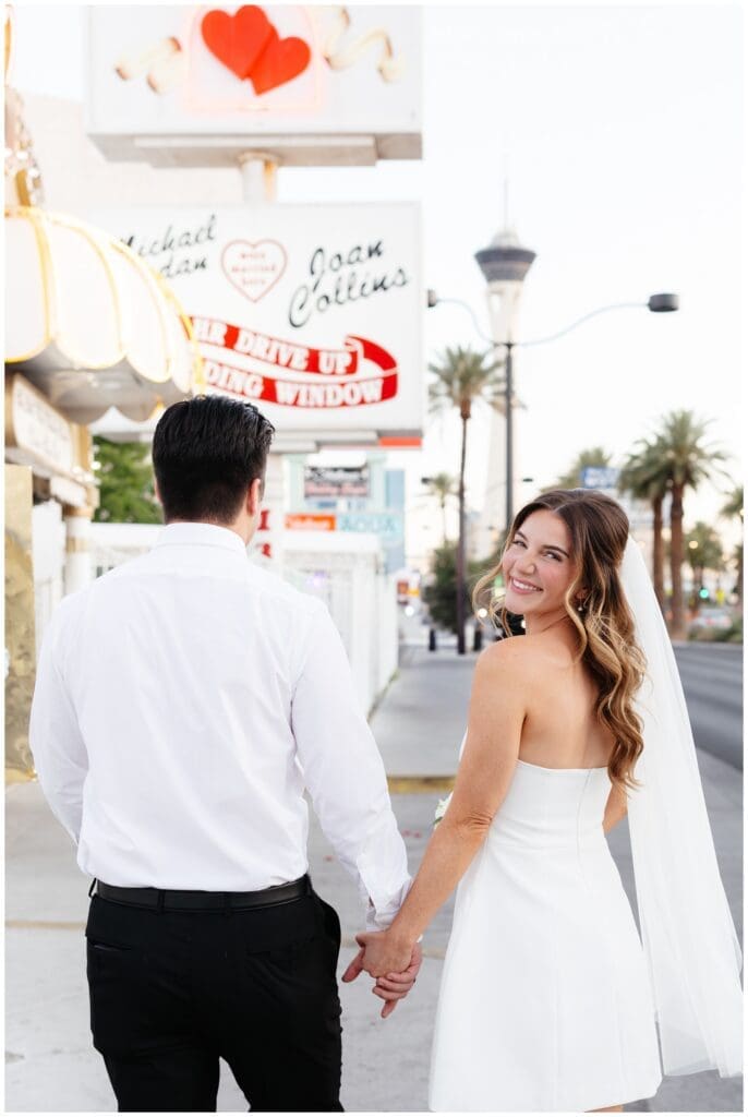 Bride and groom walking outside the Little White Chapel in Bailey Hart Photography's Las Vegas, NV photography spotlight