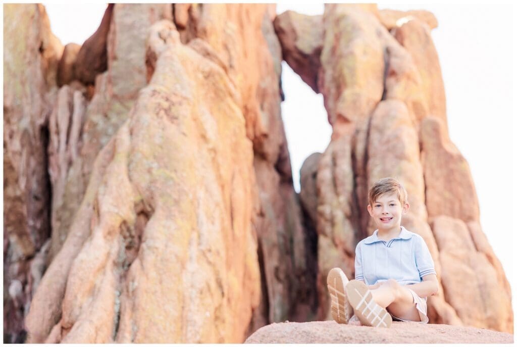 Young boy sitting on the rocks during Garden of the Gods family photos