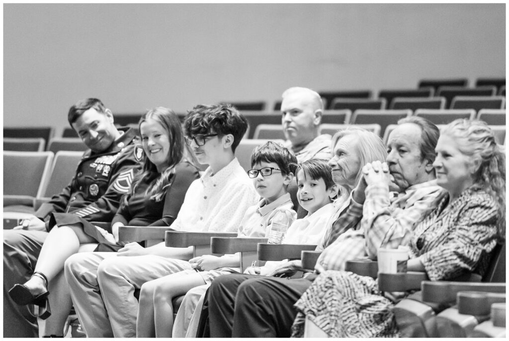 Family smiling during Fort Carson retirement ceremony