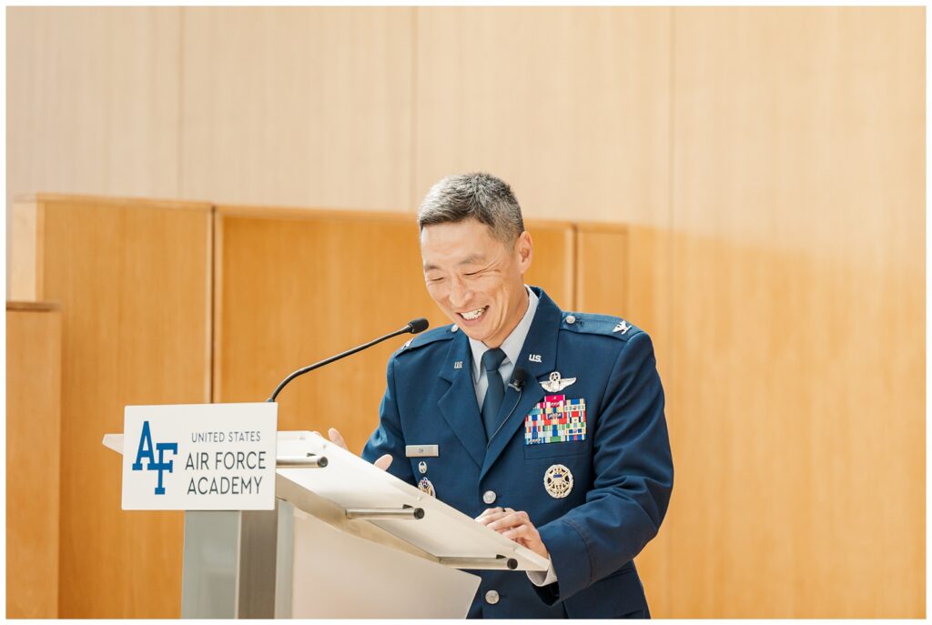 AF colonel delivering a retirement speech at a USAFA photography session